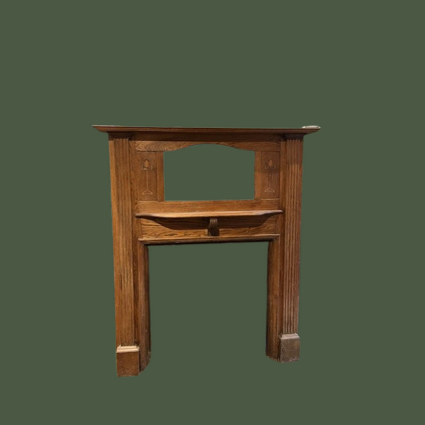Attractive original Art Nouveau oak surround with classic tulip design inlaid wood and bevelled mirror.
