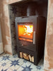 The contemporary Bohemia X30 cube stove installed with customer's fireplace tiles, creating a real focal point.