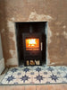 The contemporary Bohemia X30 cube stove ideal for small fireplace openings sits on the stunning Metropolis Star  Indigo fireplace tiles (customer provided), making a bold fireplace statement.