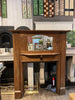 Attractive original Art Nouveau oak surround with classic tulip design inlaid wood and bevelled mirror.