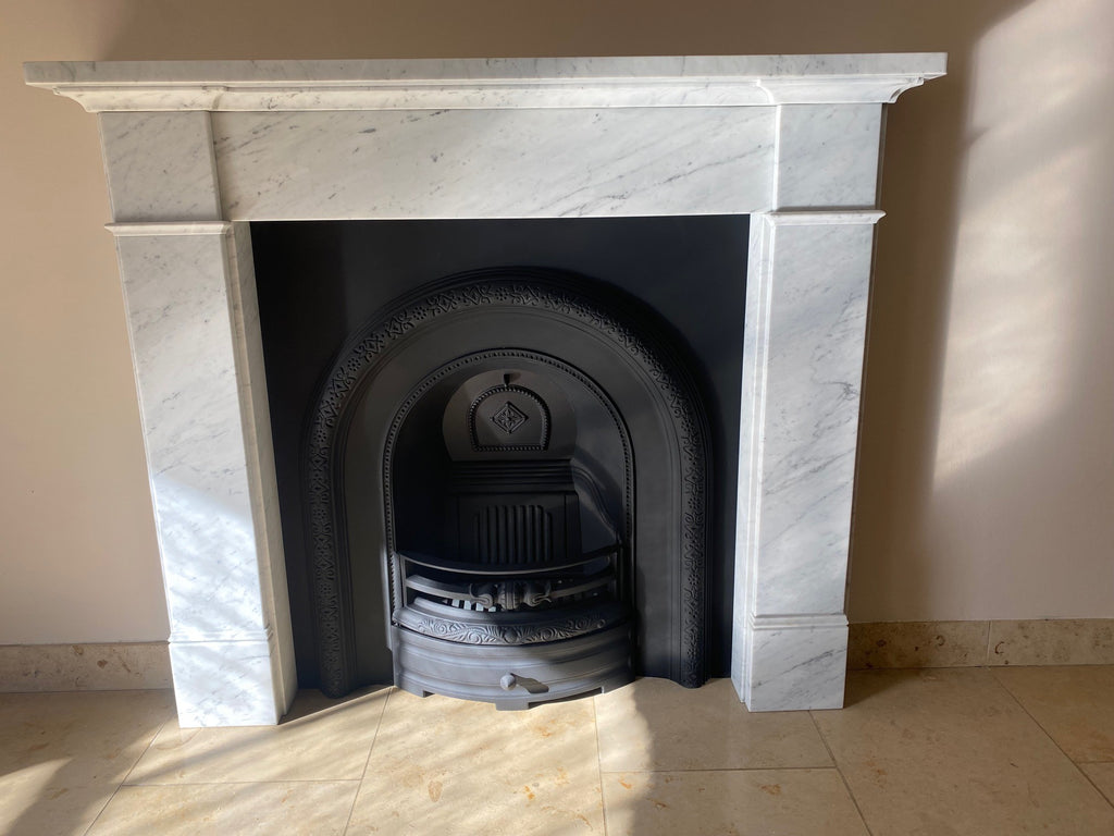 Decorative flair, the Silsoe Carrara Marble surround complements the Claydon cast iron arched insert