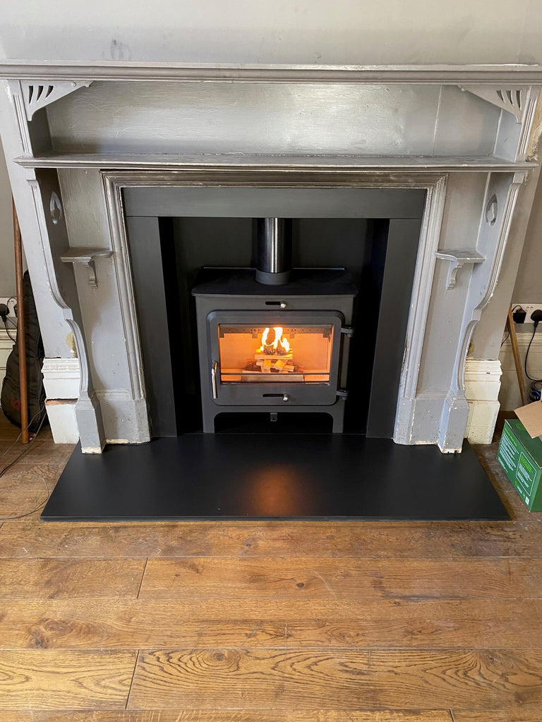 Clarity Vision Wood burner with cushioners and Edwardian surround