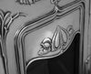 Close up of the Jasmine Art Nouveau Style cast iron fireplace, framed beautifully with an orchid stem design and an elegantly detailed canopy.