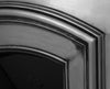 An Early Victorian traditional full polish cast iron fireplace insert with an elegantly simple and wide half-arched opening, close up