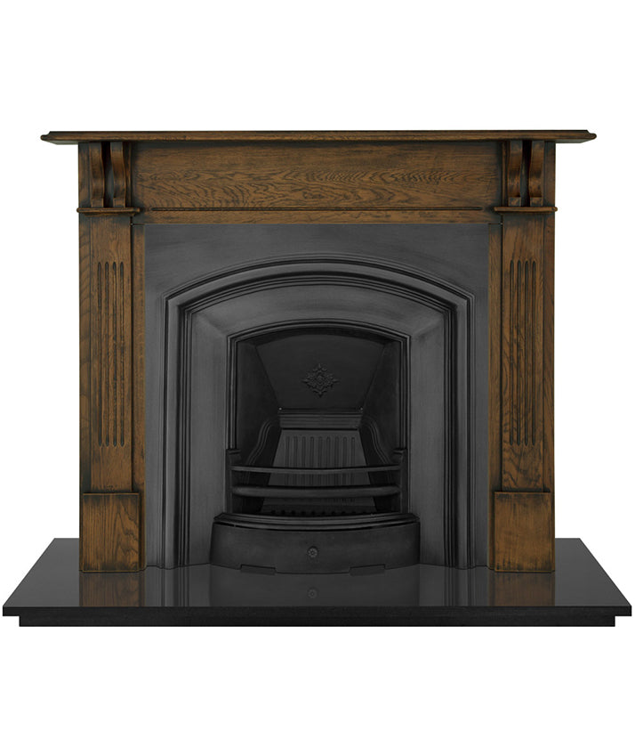 An Early Victorian  traditional black cast iron fireplace insert with an elegantly simple and wide half-arched opening.