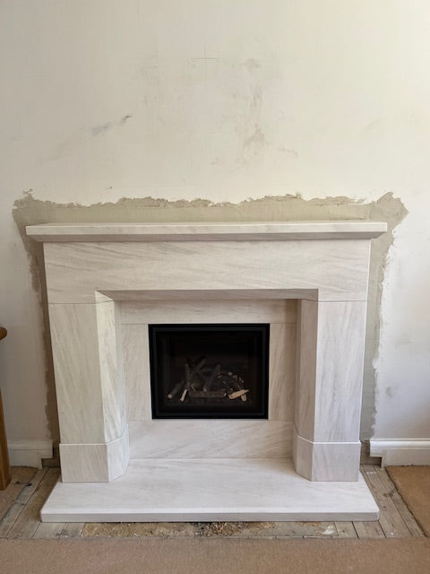 The Parrona Portuguese limestone fireplace suites makes a bold statement, featuring the contemporary high performance Design Line 500 insest gas fire.