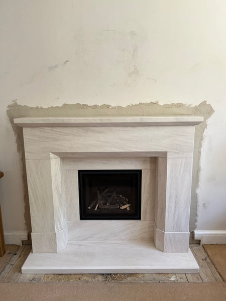 The Parrona Portuguese limestone fireplace suites makes a bold statement, featuring the contemporary high performance Design Line 500 insest gas fire.