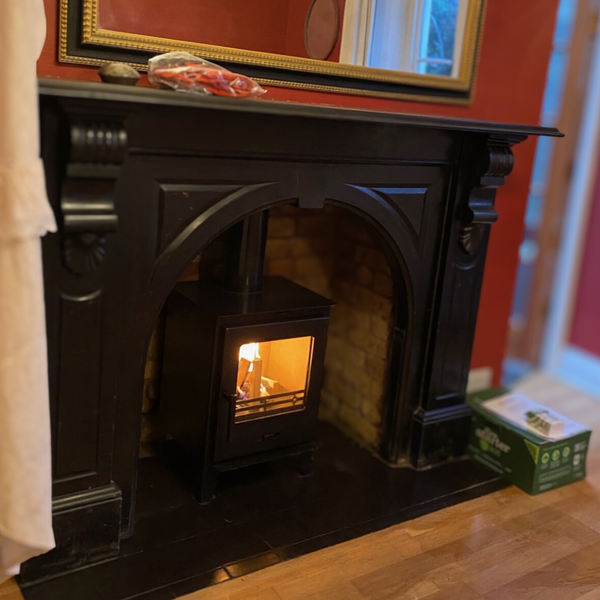 The Nu-Flame Taurus 400 multi fuel contemporary style stove. In keeping the Victorian surround, they  create a striking focal point in period properties. The stove is an economical choice for solid fuel heating. The black handle provides practical control.