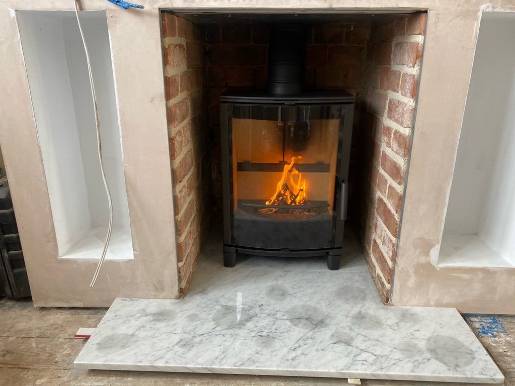 recently installed Capital FIreplaces Panamera with Prime Legs, Carrara marble t-shaped hearth
