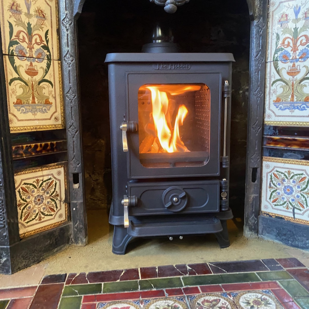 The compact Hobbit SE multi fuel stove is purpose-built for small fireplace spaces, fitting seamlessly into confined areas where standard stoves cannot. Its slim design preserves original features whilst retaining  the customer's decorative cast iron tiled surround an while replacing an inefficient open fire with a high-performance heating solution. Upgrade without renovation.
