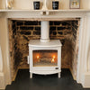 The Carron ECO 5kw stove in cream enamel and matching stove pipe featuring the cleaned brickwork