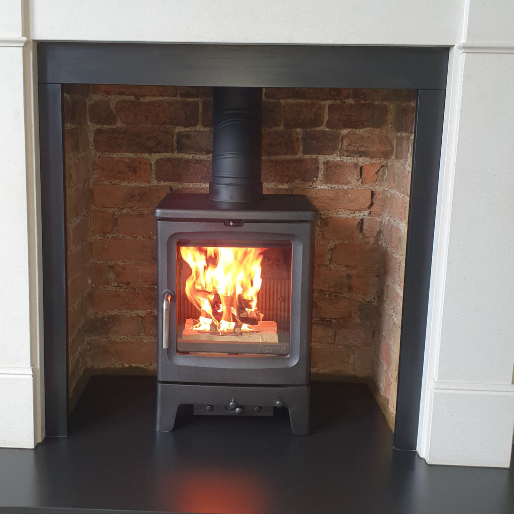 Recently installed Salfire Peanut 5 wood burning stove in a cleaned brick chamber