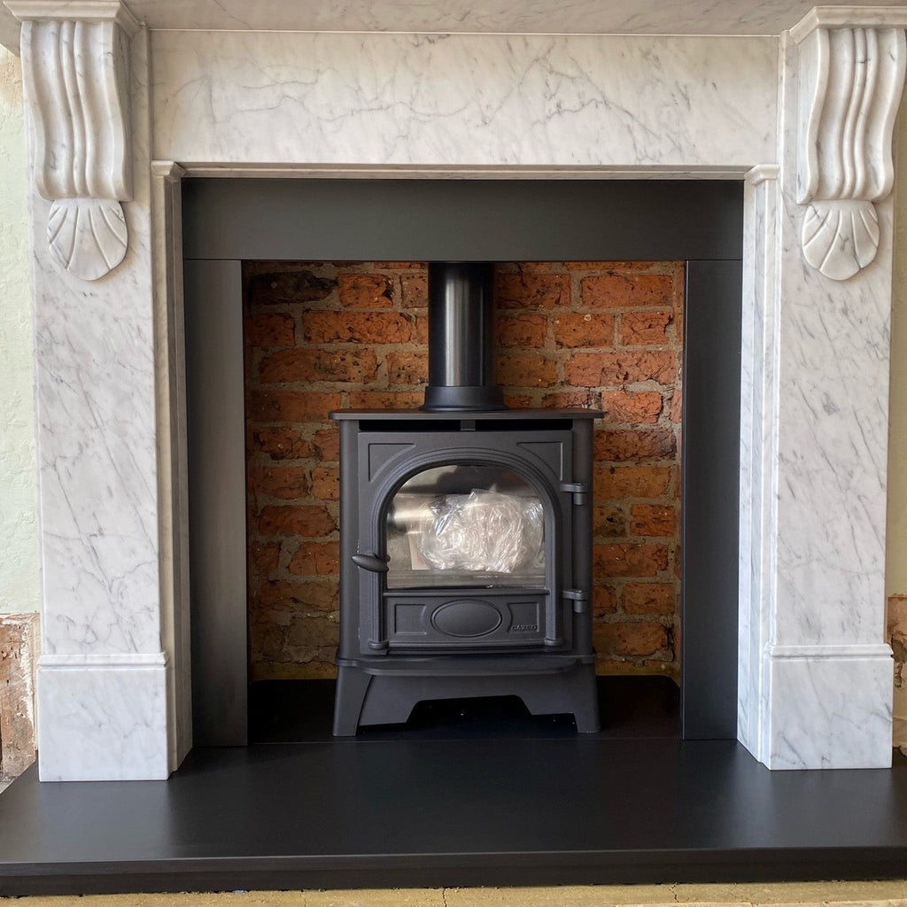 Stovax Stockton 5 Ecodesign Plus installed featuring cleaned brickwork chamber with Nuffield Carrara marble surround, honed slate hearth. 